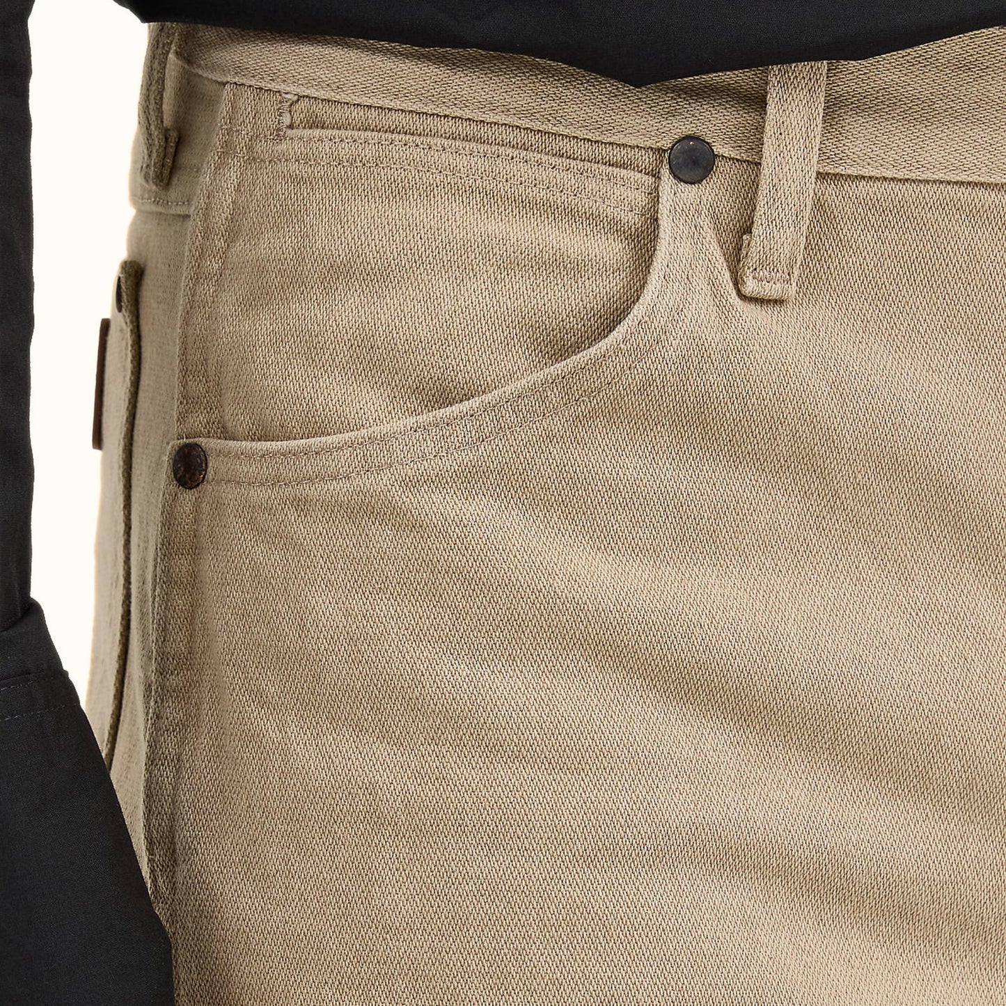 Wrangler beige cowboy jeans close-up fabric pocket detail