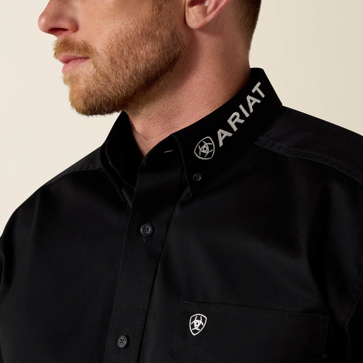 Close-up of collar and chest detail on Ariat Team Logo Twill Classic Fit Shirt in black