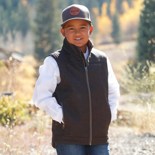 Front view of boy wearing Cinch Boys Bonded Vest in brown