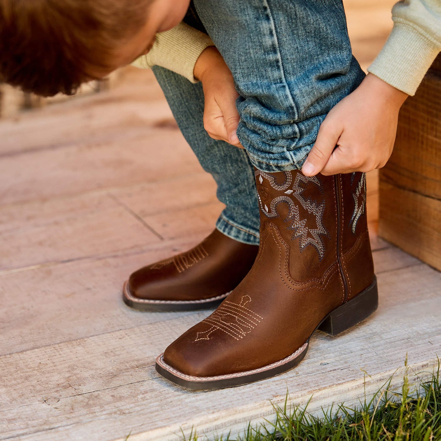 Child wearing Tombstone western boots outdoors