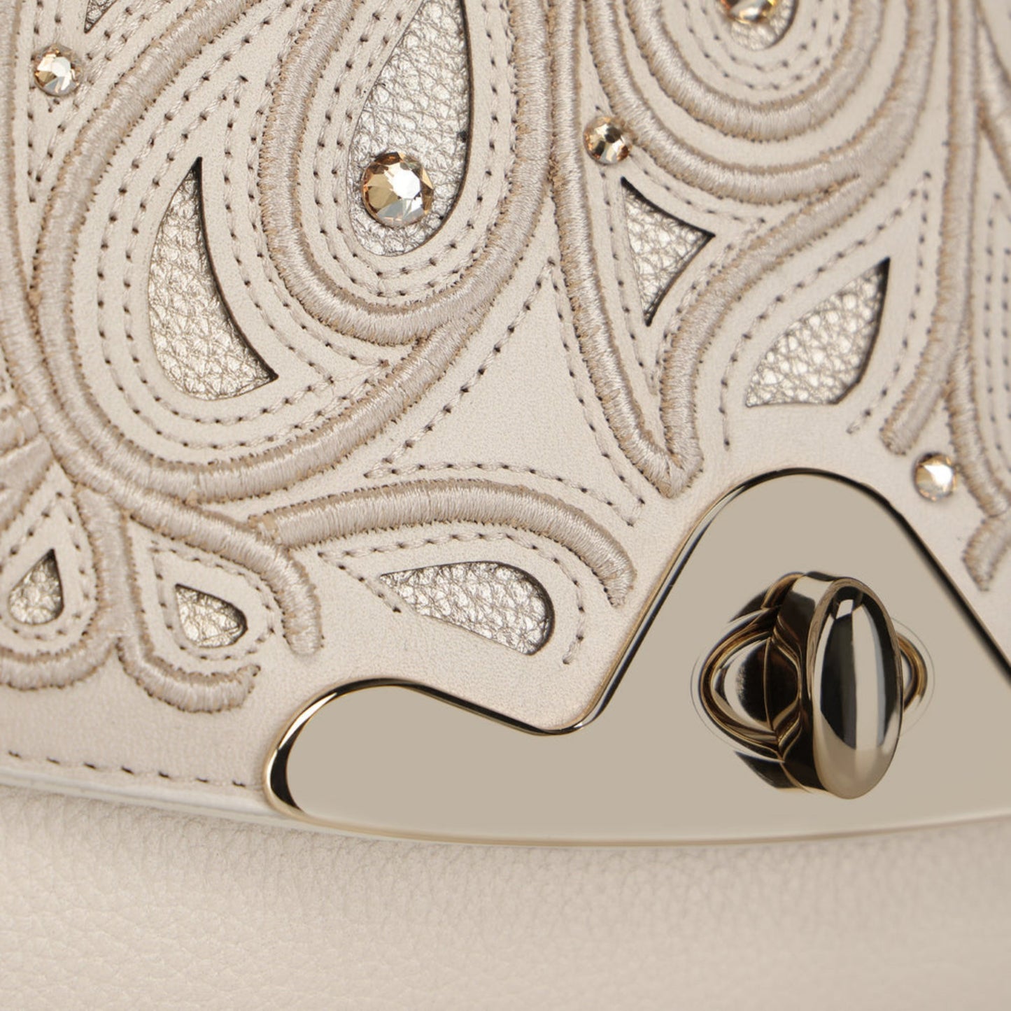 Close-up of embossed leather and crystal detail on Cuadra Women’s Beige Bovine Leather Shoulder Bag Clutch