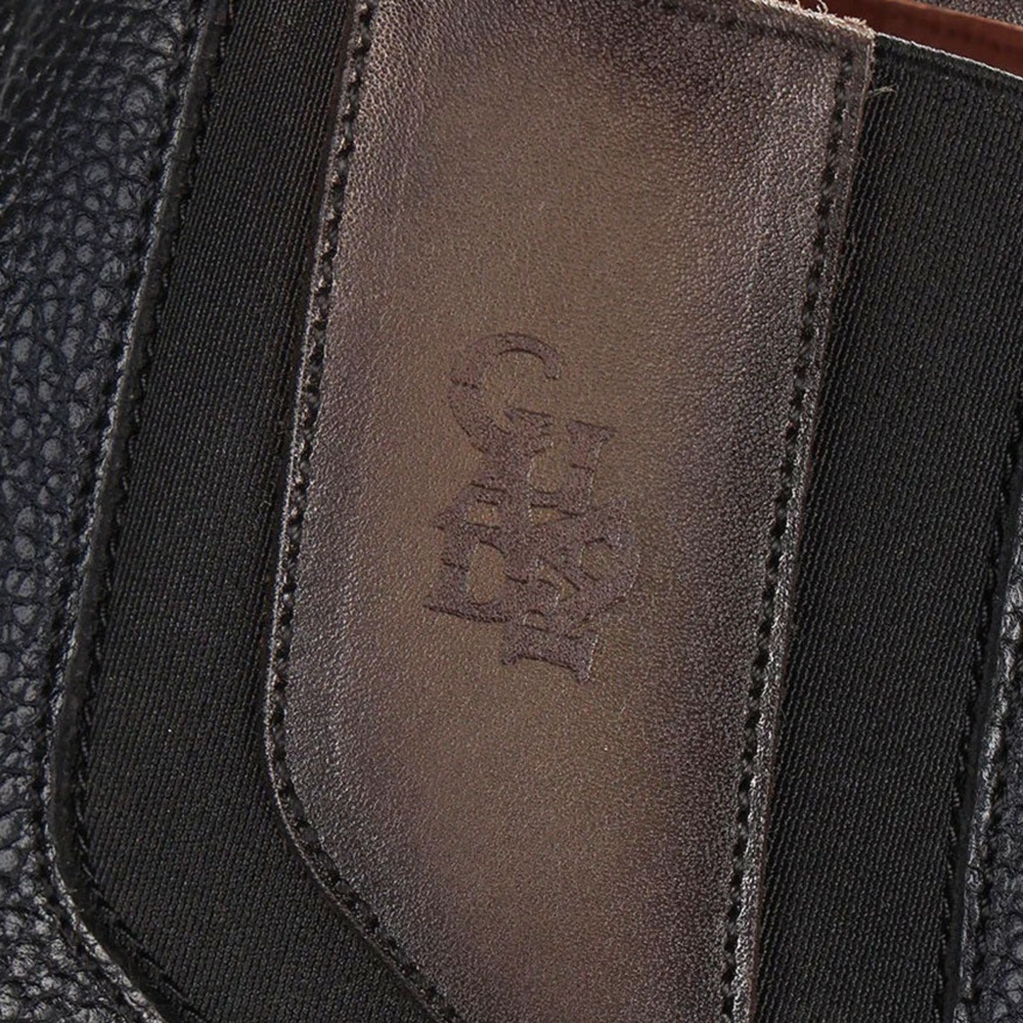 Close up detail on Cuadra Black Ostrich Zipper & Elastic Square Toe Boot