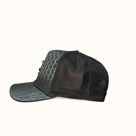 Side view of black Cuadra patterned cap with embroidered logo patch