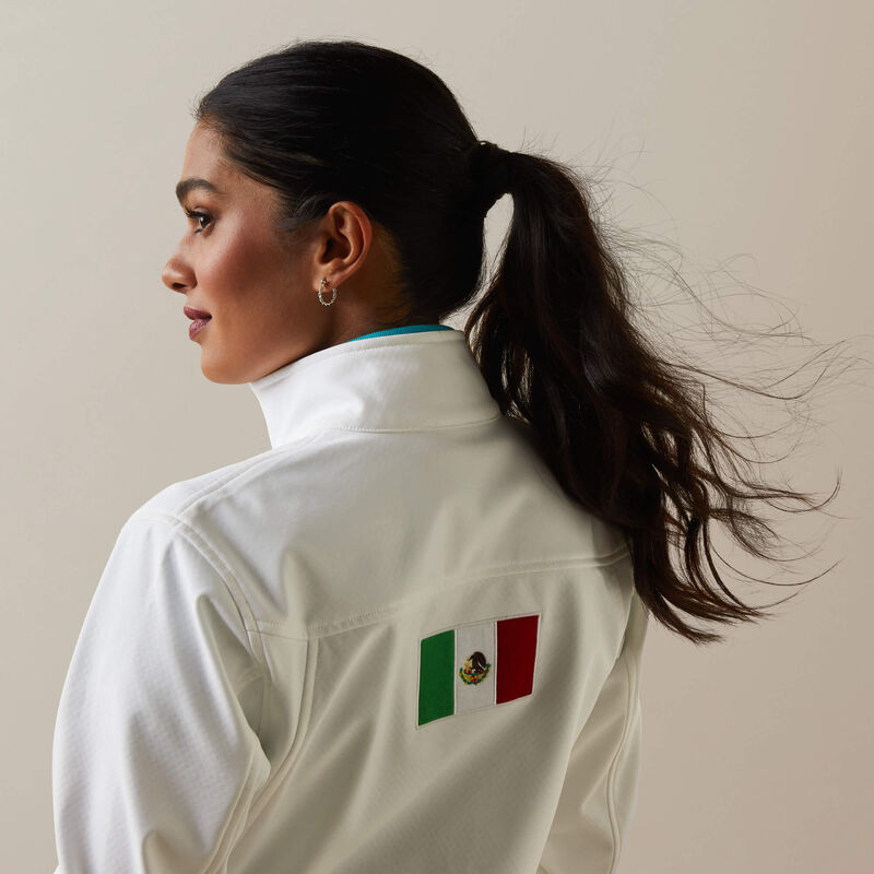 Woman wearing Ariat Classic Team Softshell Mexico Water Resistant Jacket in white back view