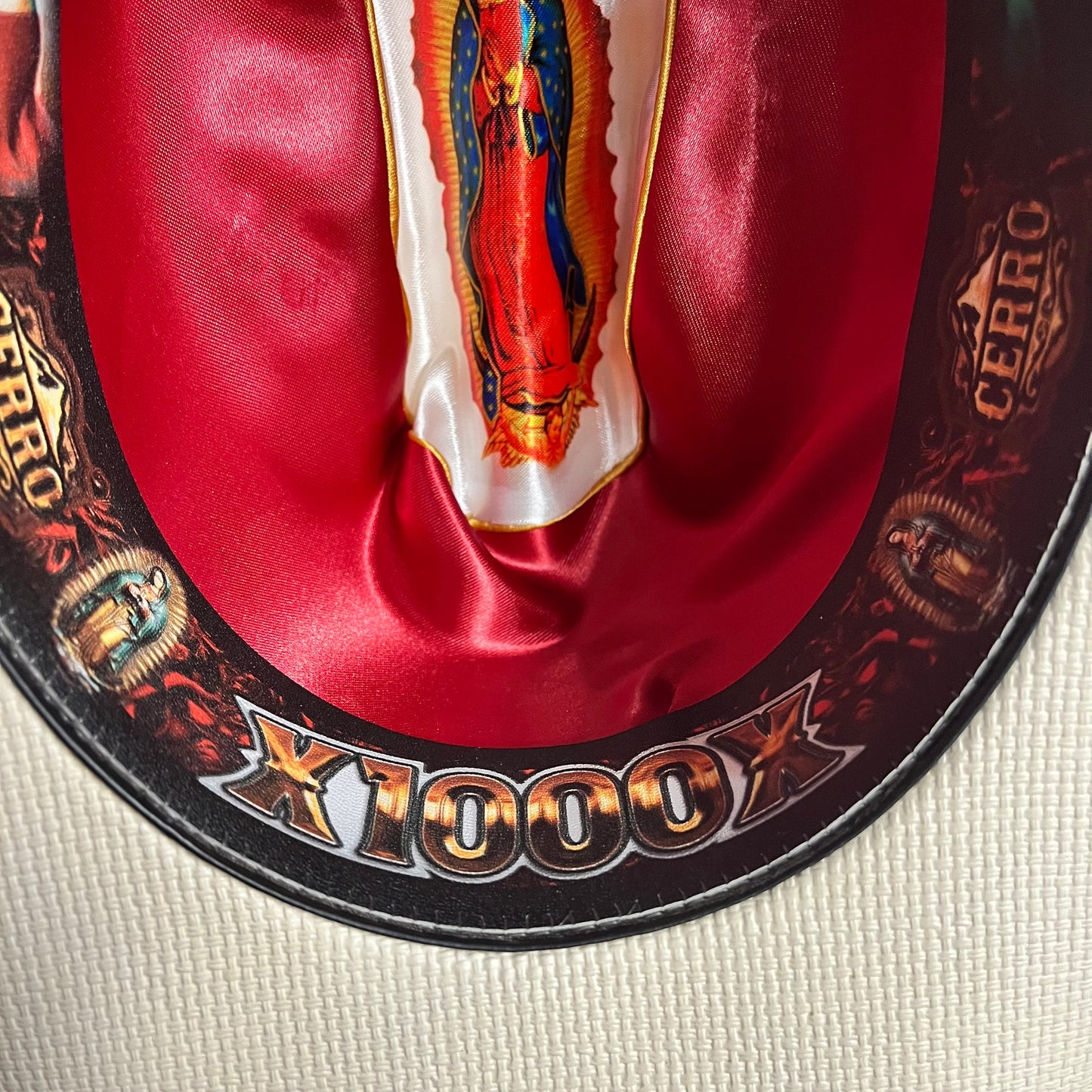 Close-up of red interior decorative detail on Cerro 1000X Virgen Maria Black Hat Band Hat