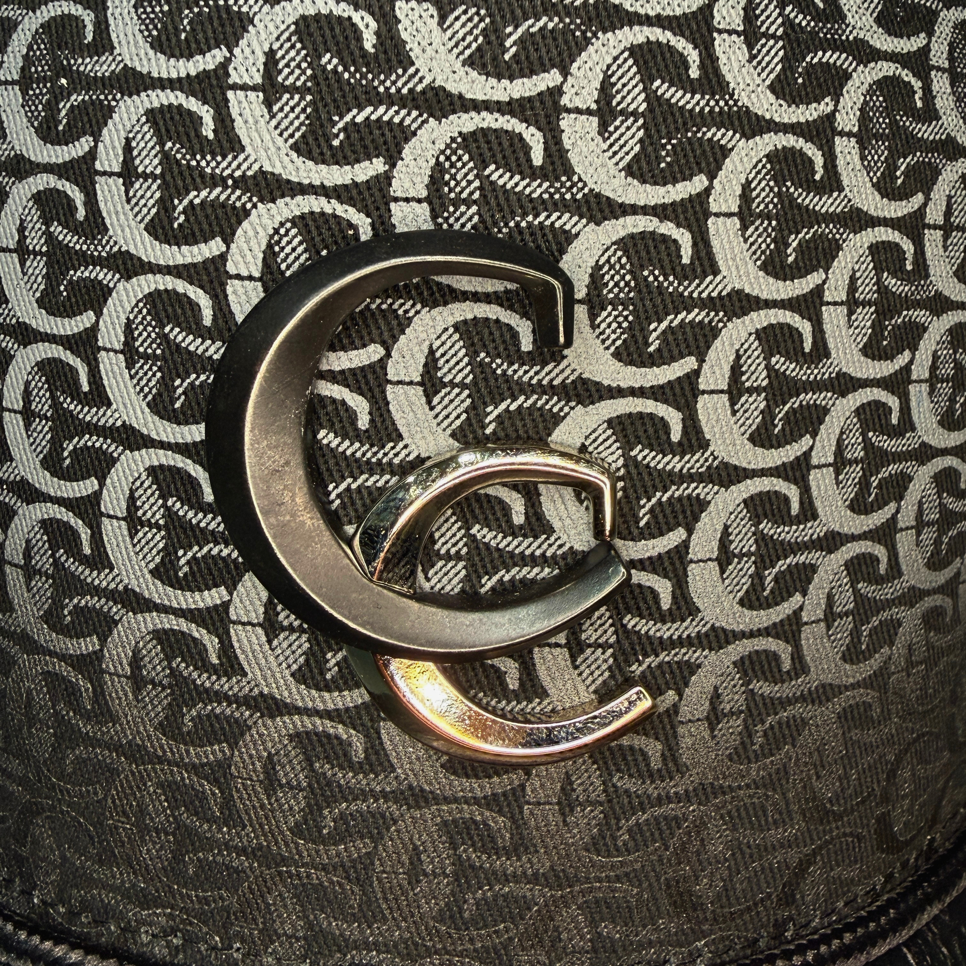 Close-up detail of black patterned fabric and Cuadra logo