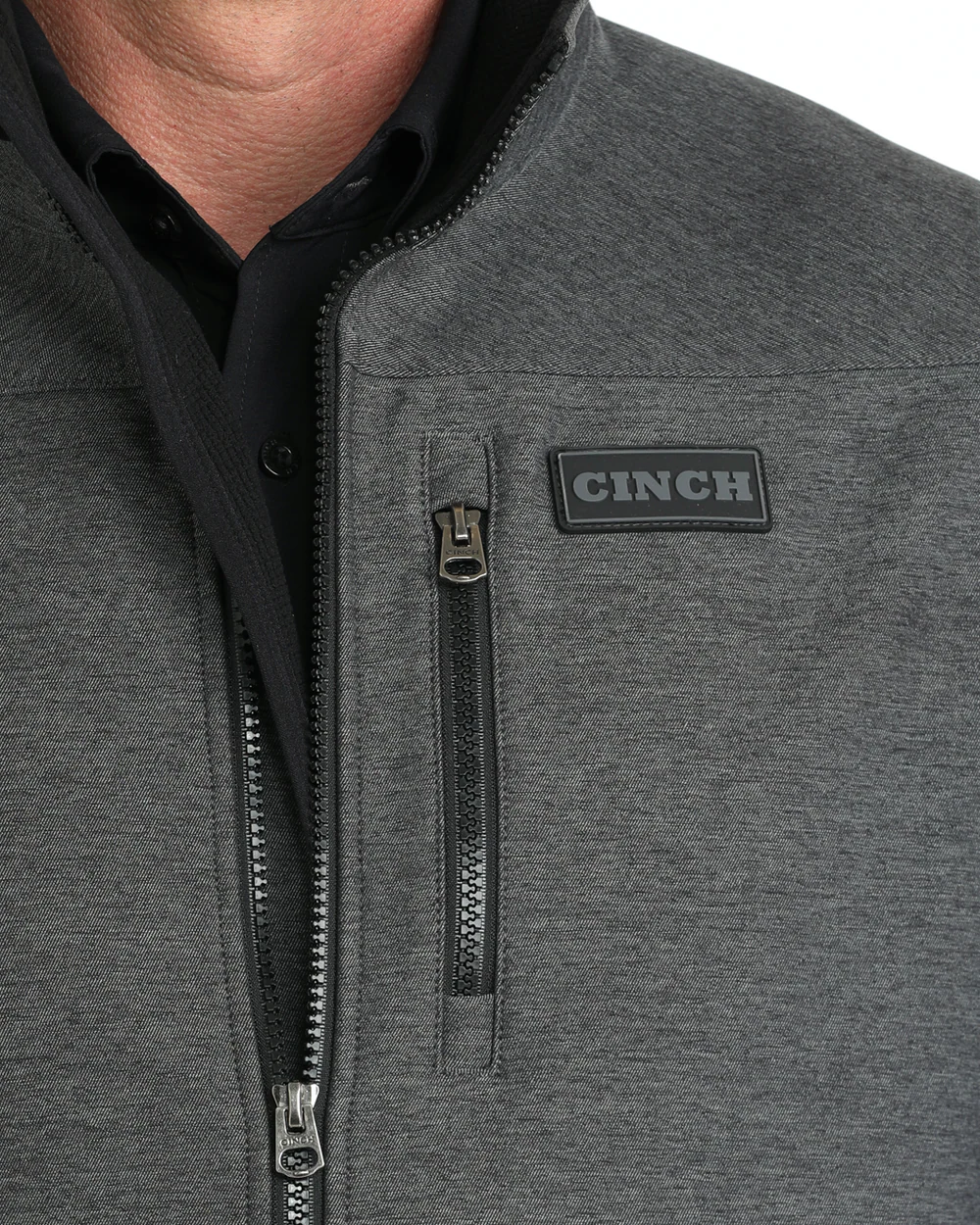 Close-up view of Cinch Men’s Bonded Vest chest logo and zipper detail