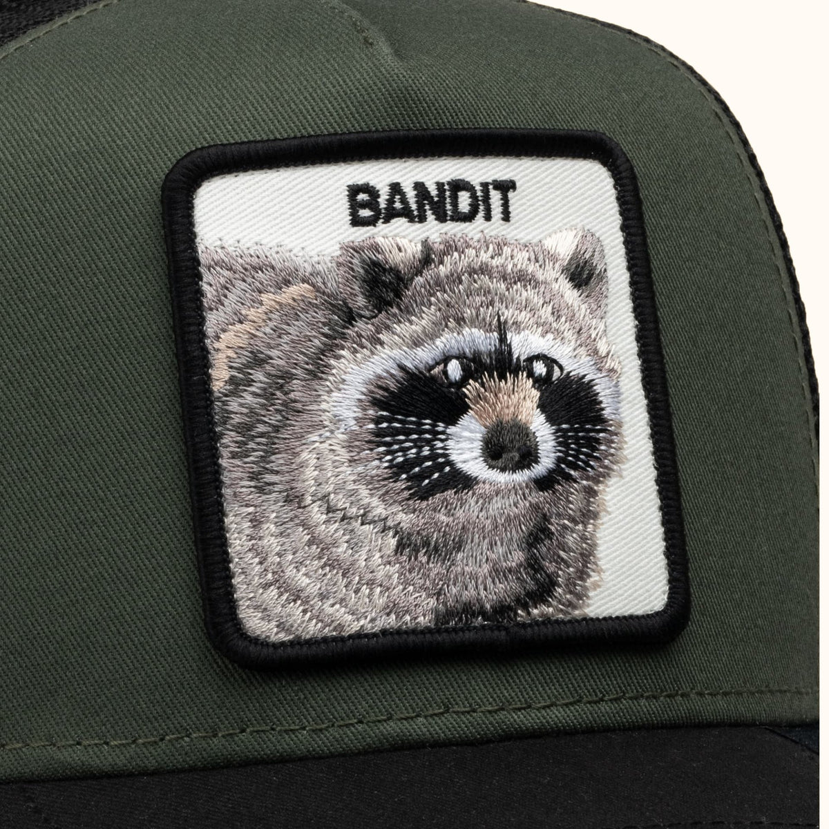 Goorin Bandit olive and black trucker hat front close-up view