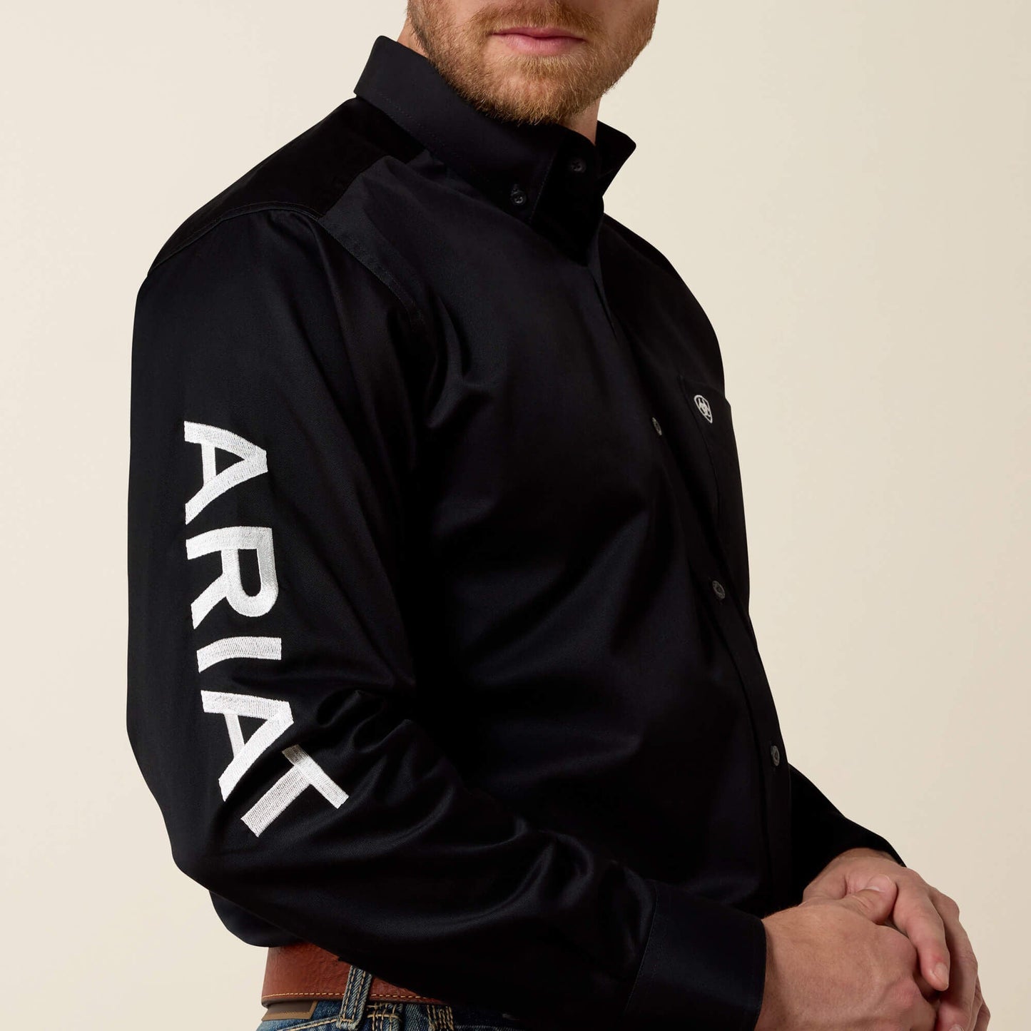Close-up of sleeve logo detail on Ariat Team Logo Twill Classic Fit Shirt in black